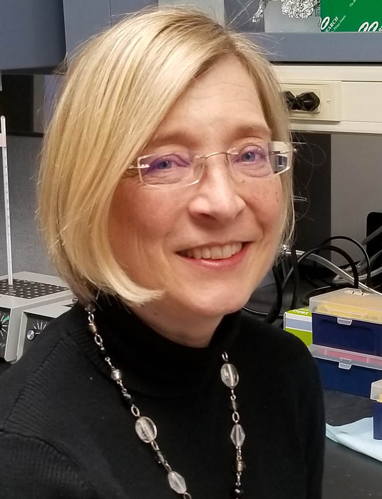 A head-and-shoulders professional photo of Laura Carrel, MA, PhD
