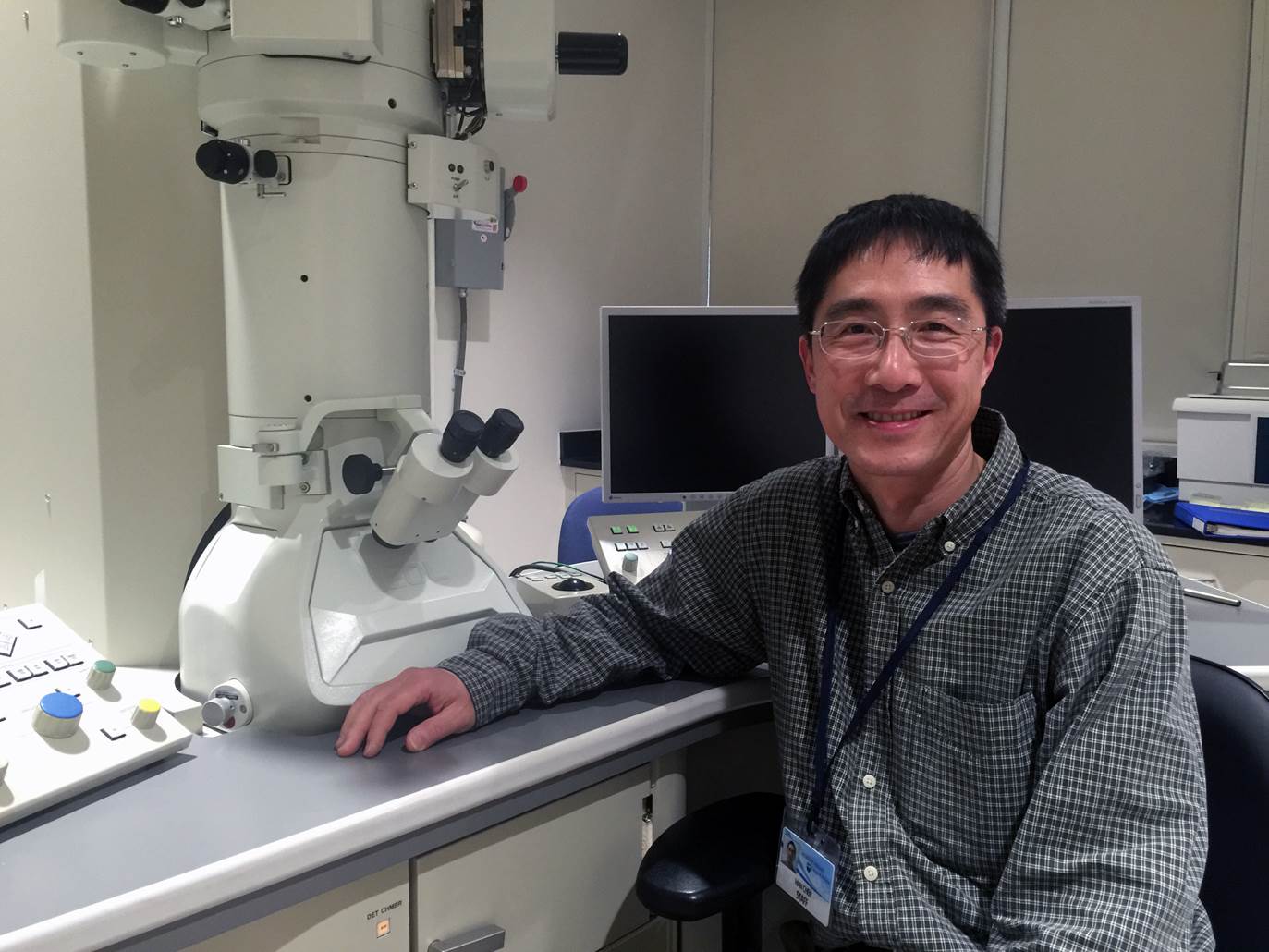 Dr. Han Chen is pictured with Penn State College of Medicine's transmission electron microscope.