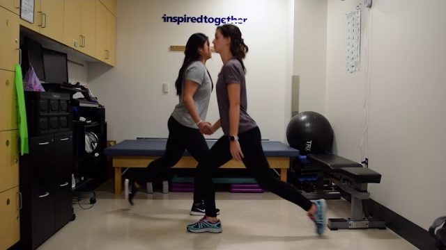 A still from a video shows two people performing the Lunges with a Parner exercise.