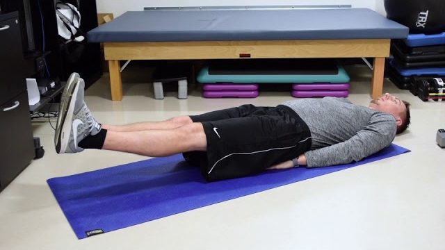 A still from a video shows a person performing the Six-Inch Ankle Raise exercise.