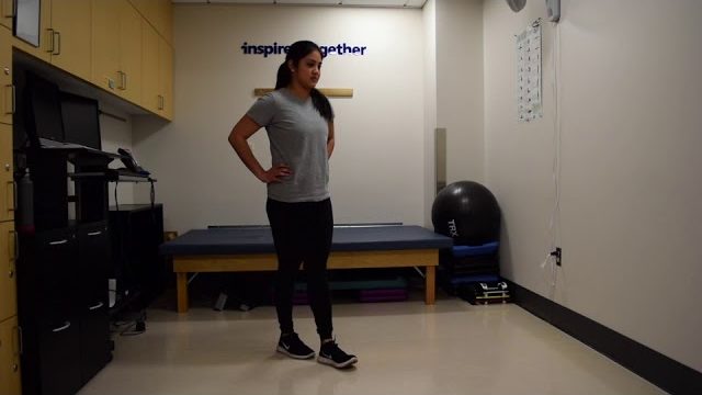 A still from a video shows a person performing the Tandem Walk exercise.