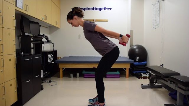 A still from a video shows a person performing the Tricep Kickbacks exercise.