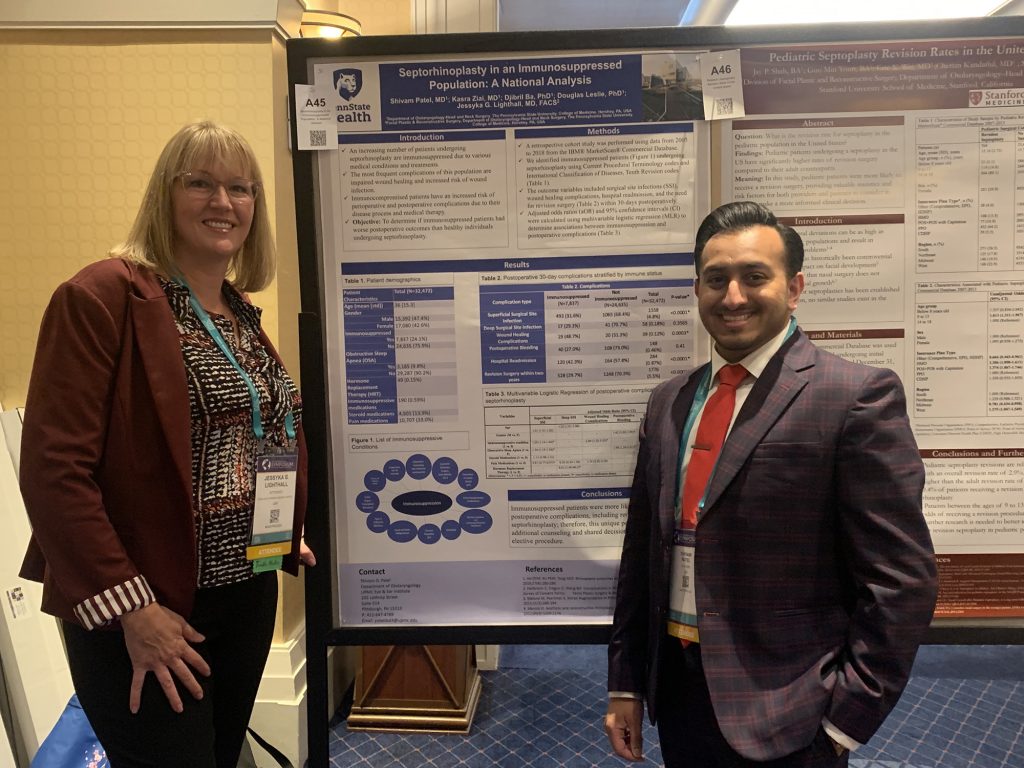 Dr. Jessyka Lighthall and Shivam Patel stand on either side of a poster they presented.