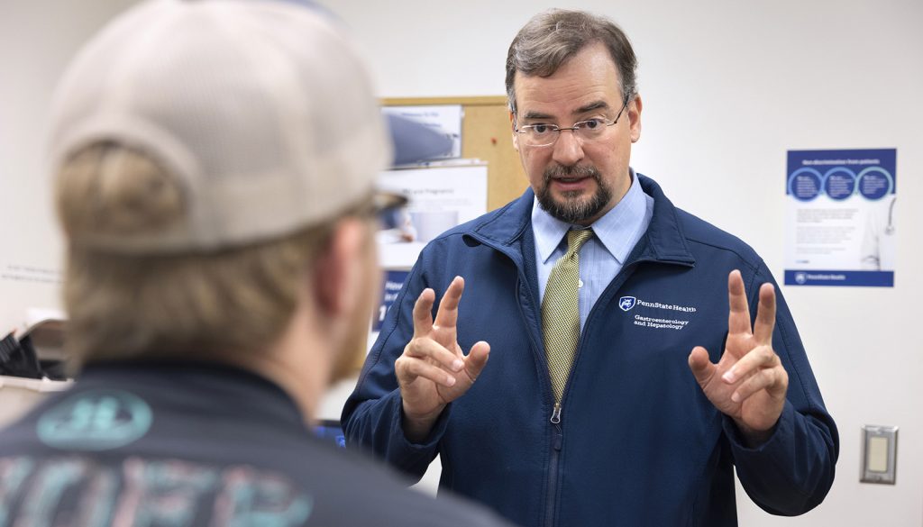 Dr. Matthew Coates talks with a patient at the Carlino Family IBD Center at Penn State Health Milton S. Hershey Medical Center.