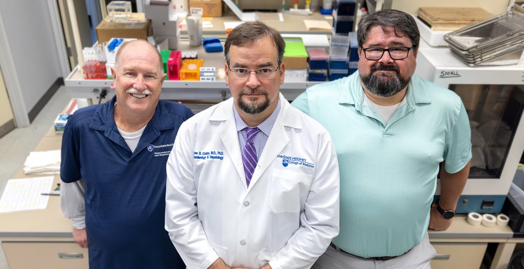 From left, Jeffrey Small, Dr. Matthew Coates and August Stuart pose for a portrait in Coates' lab.